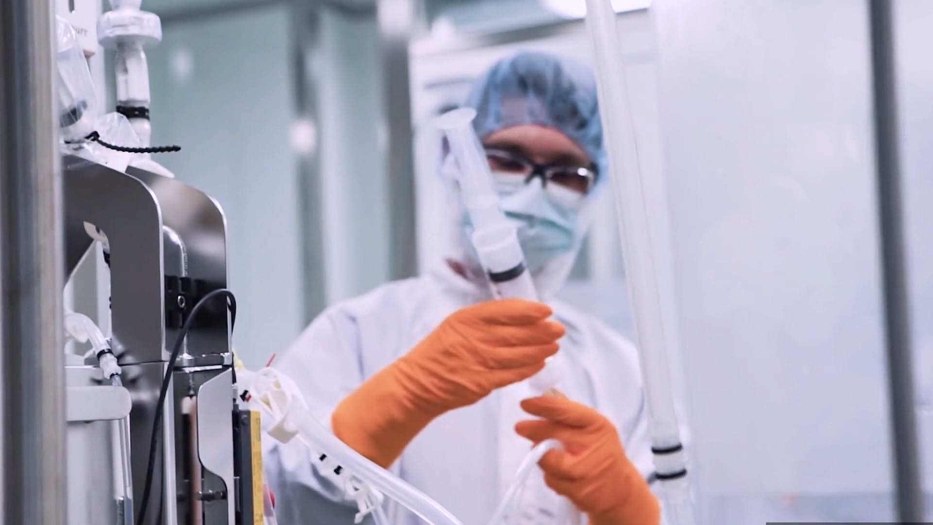 A researcher adjusting laboratory apparatus