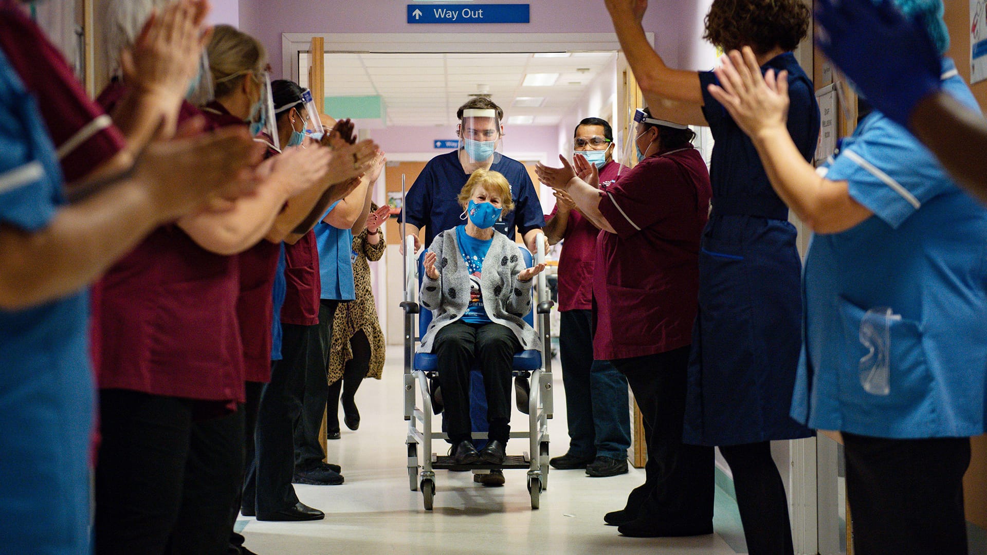 Hospital employees applaud Maggie Keenan – the first person to be vaccinated with the active ingredient Comirnaty